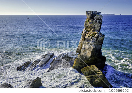 Blue sea waves beat against Nau dos Corvos or Crows nest rock near Peniche peninsula, Portugal at sunny day. Atmospheric haze, Berlengas islands, Cabo Carvoeiro viewpoint, travel destination, Atlantic Blue sea waves beat against Nau dos Corvos or Crows nest rock near Peniche peninsula, Portugal at sunny day. Atmospheric haze, Berlengas islands, Cabo Carvoeiro viewpoint, travel destination, Atlantic 109666902