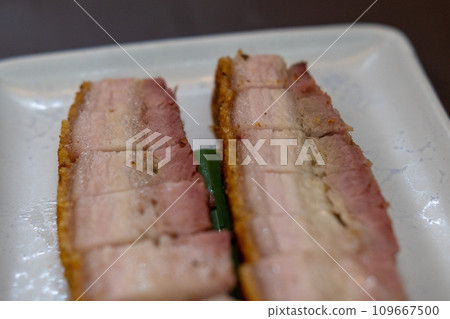 Roasted crispy pork served on a plate, ready to eat Roasted crispy pork served on a plate, ready to eat 109667500