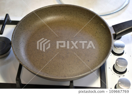The frying pan is on the gas stove. 109667769