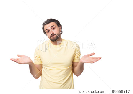 young inspired man with a black beard and mustache dressed in a t-shirt young inspired man with a black beard and mustache dressed in a t-shirt 109668517