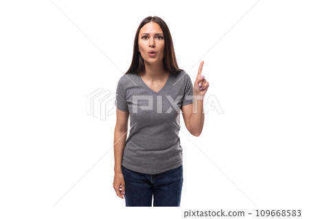 young well-groomed caucasian woman with dark straight hair is dressed in a casual gray t-shirt on a 109668583