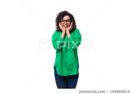 young well-groomed secretary brunette woman with curly hair is dressed in a green blouse 109668614
