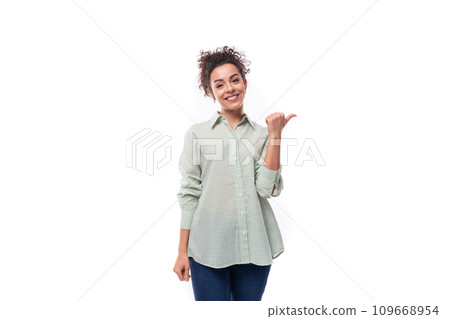 positive smiling young woman with curly messy hairstyle dressed in a shirt 109668954