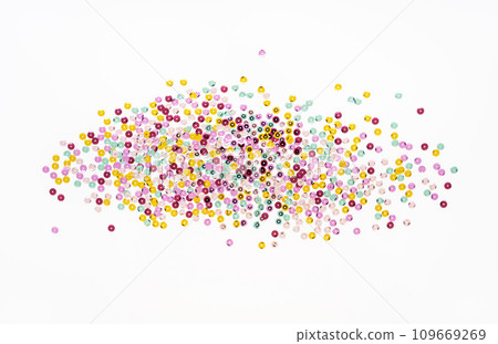 Various colored sequins on a white background. Various colored sequins on a white background. 109669269