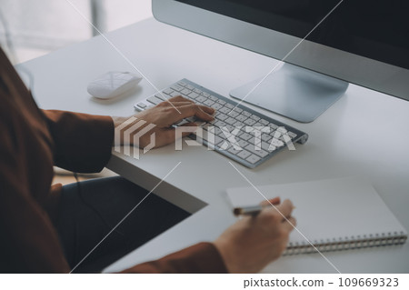 Customer service representative with curly hair talking through headset 109669323