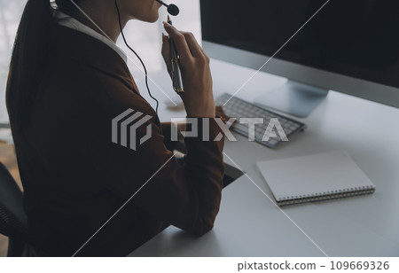 Customer service representative with curly hair talking through headset Customer service representative with curly hair talking through headset 109669326
