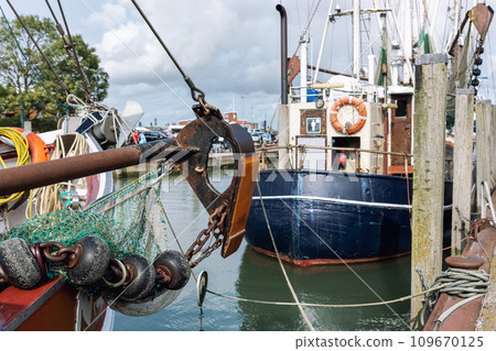 Traditional old german fishing cutter boats moored Neuharlingersiel harbor Wadden sea East Frisia Northern Germany. Commercial fish crab shrimp trawler beam trawl nets North Sea small port city Traditional old german fishing cutter boats moored Neuharlingersiel harbor Wadden sea East Frisia Northern Germany. Commercial fish crab shrimp trawler beam trawl nets North Sea small port city 109670125