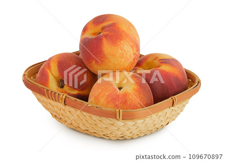 Ripe peach fruit in a wicker basket isolated on white background with full depth of field 109670897