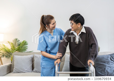 caregiver or nurse help support elderly are standing up with walker at home caregiver or nurse help support elderly are standing up with walker at home 109670934