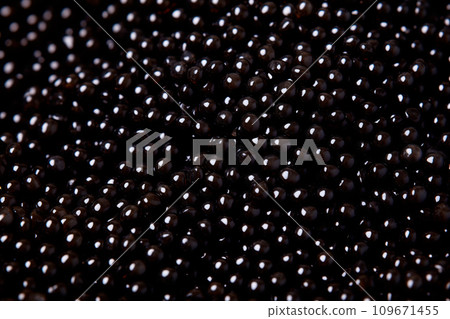 Closeup of natural black caviar as background, texture of expensive luxury fresh sturgeon caviar macro photo. Closeup of natural black caviar as background, texture of expensive luxury fresh sturgeon caviar macro photo. 109671455