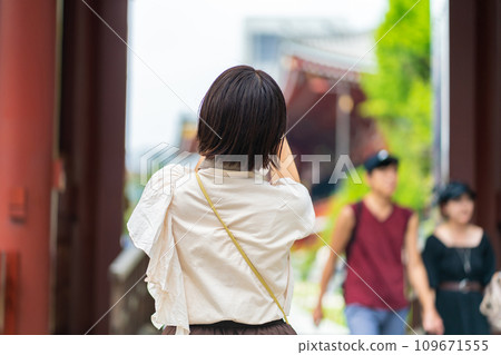 A woman traveling A woman taking pictures at a tourist spot A woman enjoying sightseeing A woman strolling at a tourist spot A woman traveling on a holiday A woman traveling A woman taking pictures at a tourist spot A woman enjoying sightseeing A woman strolling at a tourist spot A woman traveling on a holiday 109671555
