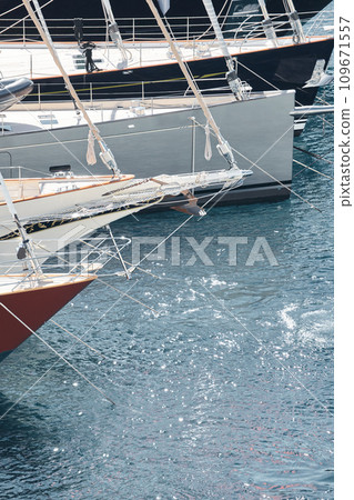 Sun glare on glossy board boats, azure water, tranquillity in port Hercules, bows of moored sailing boats at sunny day, megayachts, Monaco, Monte-Carlo Sun glare on glossy board boats, azure water, tranquillity in port Hercules, bows of moored sailing boats at sunny day, megayachts, Monaco, Monte-Carlo 109671557