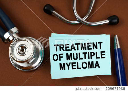 On a brown surface there is a stethoscope, a pen and blue stickers with the inscription - treatment of multiple myeloma On a brown surface there is a stethoscope, a pen and blue stickers with the inscription - treatment of multiple myeloma 109671986