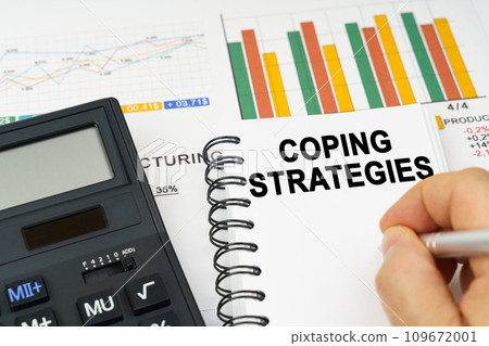 There is a calculator on the table, business charts, a man made a note in a notebook - Coping Strategies There is a calculator on the table, business charts, a man made a note in a notebook - Coping Strategies 109672001