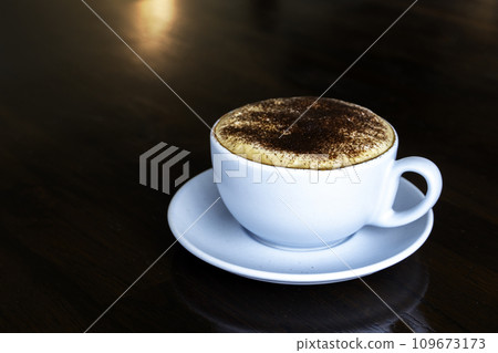 Cappuccino or latte with frothy foam, coffee cup top view on wooden background. Cafe and bar, barista art concept. 109673173