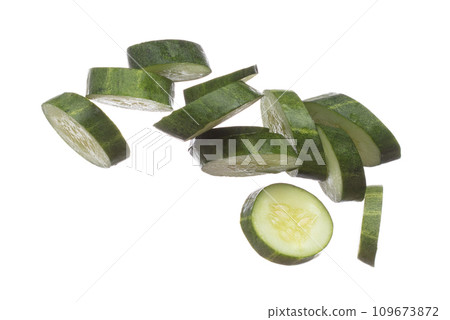 Cucumber fly fall, green fresh vegetable cucumber cut chop slice. Organic fresh vegetable with eaten leaf of long cucumber, close up texture. White background isolated freeze motion high speed shutter 109673872