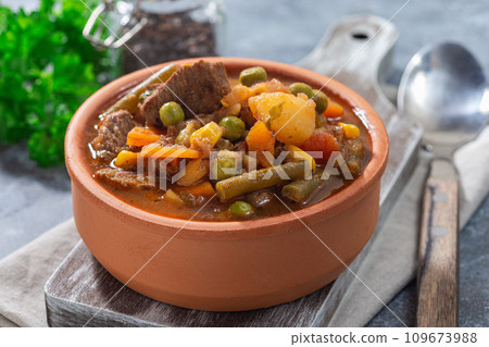 Vegetable beef stew with potato, green beans, carrot, peas and corn, in ceramic bowl, horizontal Vegetable beef stew with potato, green beans, carrot, peas and corn, in ceramic bowl, horizontal 109673988
