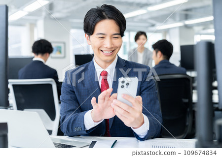 A young businessman working in the office A young businessman working in the office 109674834