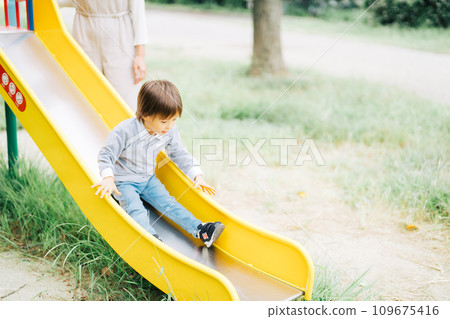 Parents and children playing on the slide 109675416