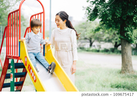 Parents and children playing on the slide Parents and children playing on the slide 109675417