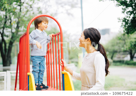 Parents and children playing on the slide 109675422