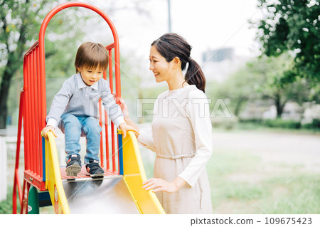 Parents and children playing on the slide Parents and children playing on the slide 109675423