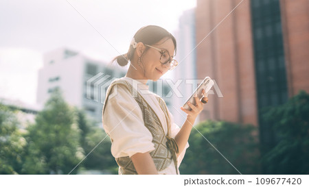 Casual business asian woman using smartphone city lifestyles with modern technology Casual business asian woman using smartphone city lifestyles with modern technology 109677420