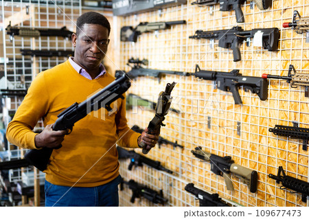 African-american man in airsoft shop 109677473