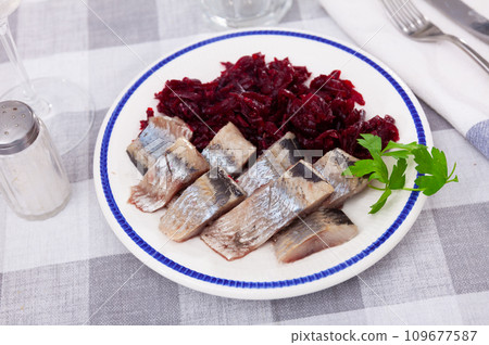 Slightly salted herring slices with grated beets and greens Slightly salted herring slices with grated beets and greens 109677587