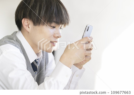 High school boy using smartphone 109677663