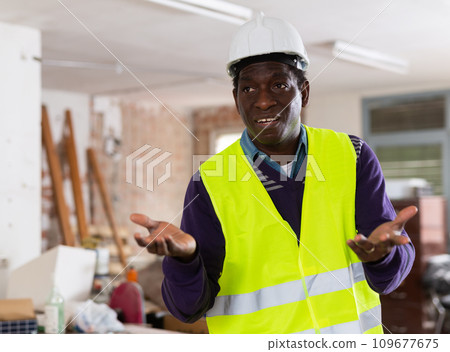 Worried puzzled architect standing in building during renovation Worried puzzled architect standing in building during renovation 109677675