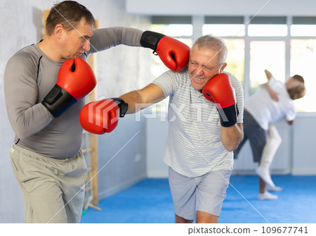 Two men training boxing fight in studio Two men training boxing fight in studio 109677741
