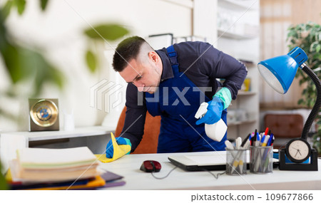 Young man cleaner working at office 109677866