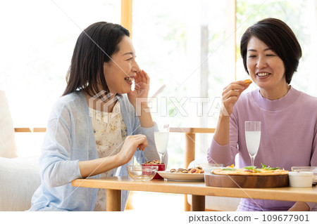 Middle-aged woman enjoying a home party 109677901