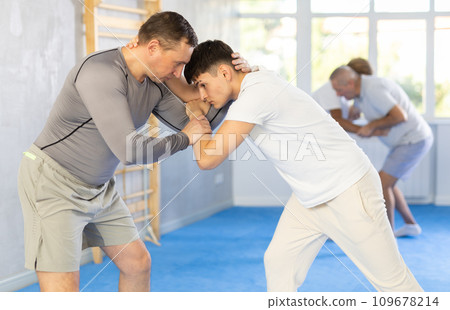 Two men training judo technique in studio Two men training judo technique in studio 109678214