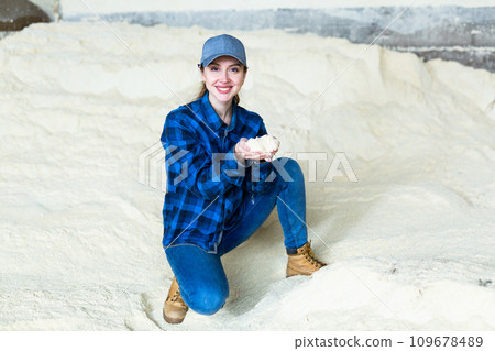 Woman agronomist squatting at bunch of corn flour Woman agronomist squatting at bunch of corn flour 109678489