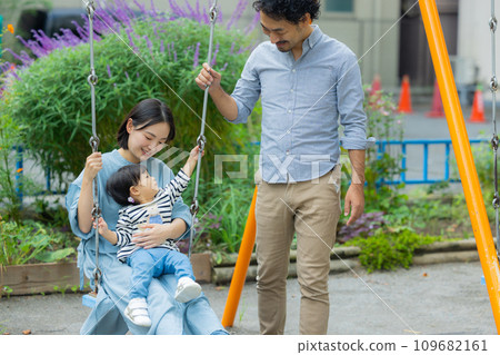 Parent and child playing in the park Parent and child playing in the park 109682161