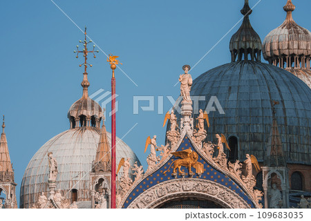 Beautiful ornate building with intricately carved and gilded domes in Venice, Italy. The architectural style and historical significance are unknown. Unspecified color scheme and surroundings. 109683035