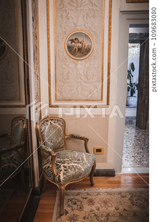 Experience the luxury and sophistication of a Venetian-style bedroom in this elegantly decorated space in Venice, Italy. Immerse yourself in the ambiance of high-quality furnishings Experience the luxury and sophistication of a Venetian-style bedroom in this elegantly decorated space in Venice, Italy. Immerse yourself in the ambiance of high-quality furnishings 109683080