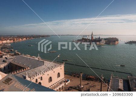 A serene and peaceful cityscape of Venice, Italy, captured from the top of a building. The view features beautiful waterways and buildings, conveying a mood of tranquility and serenity. A serene and peaceful cityscape of Venice, Italy, captured from the top of a building. The view features beautiful waterways and buildings, conveying a mood of tranquility and serenity. 109683300