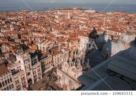 Aerial view of Venice cityscape, evoking serenity and tranquility. The image showcases the unique layout, iconic canals, and historic architecture, capturing the essence of Venice during the summer. 109683331