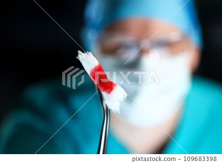 Surgeon in sterile uniform arms holding tools with bio material Surgeon in sterile uniform arms holding tools with bio material 109683398