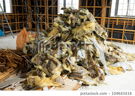 A demolished abandoned house piled with scrap materials A demolished abandoned house piled with scrap materials 109683816