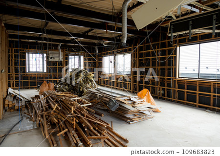 A demolished abandoned house piled with scrap materials A demolished abandoned house piled with scrap materials 109683823