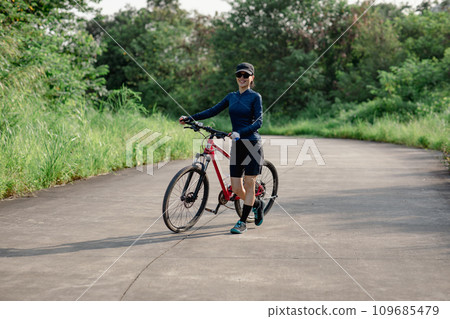 Riding bike in spring forest Riding bike in spring forest 109685479