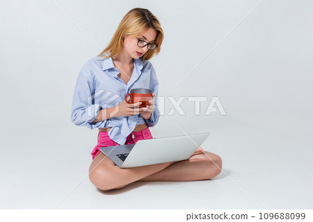 young woman sitting on the floor and using laptop young woman sitting on the floor and using laptop 109688099