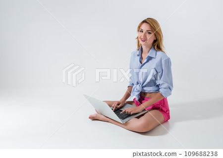 young woman sitting on the floor and using laptop young woman sitting on the floor and using laptop 109688238