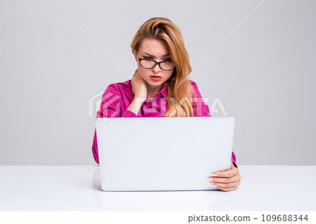 young woman sitting in the table and using laptop young woman sitting in the table and using laptop 109688344