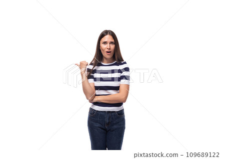 a slender young brunette caucasian woman with light make-up dressed in a striped t-shirt and jeans a slender young brunette caucasian woman with light make-up dressed in a striped t-shirt and jeans 109689122