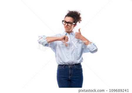 successful cute young brunette curly business woman dressed in a blue shirt is actively gesturing successful cute young brunette curly business woman dressed in a blue shirt is actively gesturing 109689241